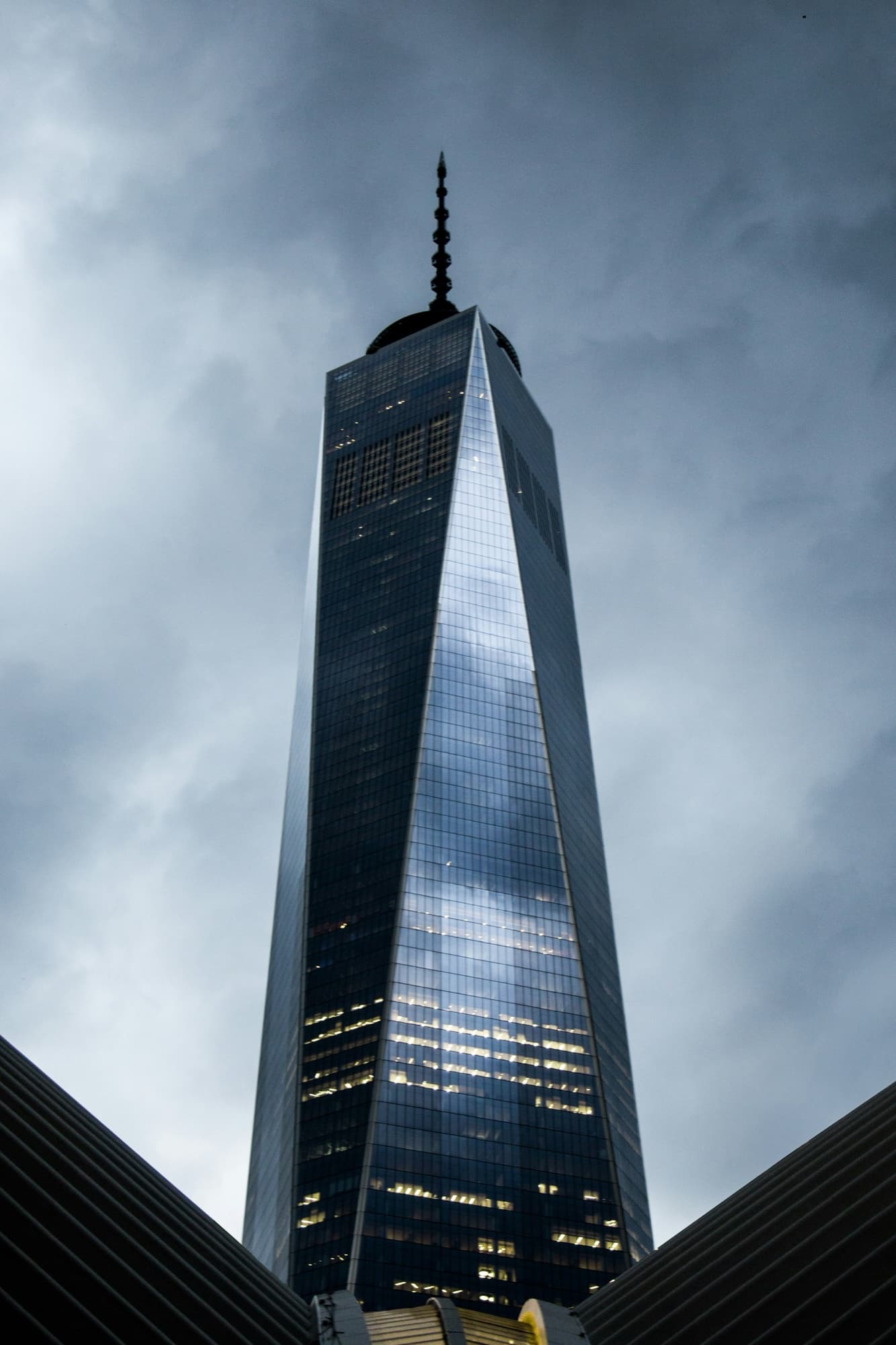 One World Trade Center in New York City, seen from below against a grey sky